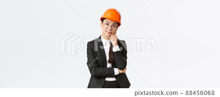 Smiling professional asian businesswoman invest money in construction, manage work at enterprise, wearing safety helmet and suit, looking pleased at camera, standing white background Smiling professional asian businesswoman invest money in construction, manage work at enterprise, wearing safety helmet and suit, looking pleased at camera, standing white background 88456068