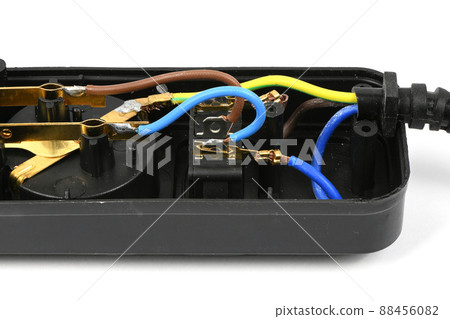 Internal device of a black plastic electrical extension cord for household appliances, isolated on white. Internal device of a black plastic electrical extension cord for household appliances, isolated on white. 88456082