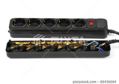 Internal device of a black plastic electrical extension cord for household appliances, isolated on white. 88456084