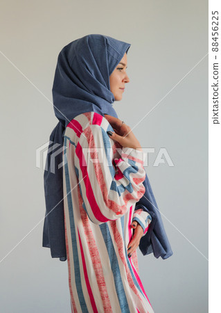 Side view profile face of young muslim woman wearing blue hijab Side view profile face of young muslim woman wearing blue hijab 88456225