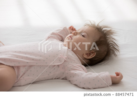 Peaceful calm sleepy cute baby girl wearing pink bodysuit 88457471
