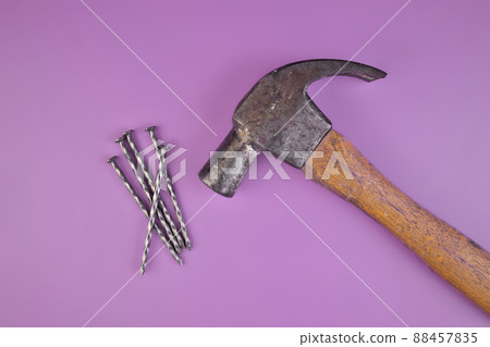 Flatlay View of Hammer and Nails Isolated on a Lavender Purple Background Flatlay View of Hammer and Nails Isolated on a Lavender Purple Background 88457835