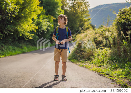 Young boy walking on a hiking pathway in a wood Young boy walking on a hiking pathway in a wood 88459002