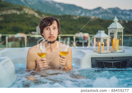 Portrait embarrassed man relaxing at hot tub to whom the woman did not come on a date. February 14 concept. St. Valentine's Day Portrait embarrassed man relaxing at hot tub to whom the woman did not come on a date. February 14 concept. St. Valentine's Day 88459277