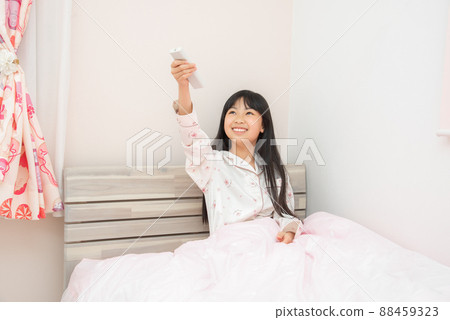 Elementary school girl who turns off the lights before going to bed in the children's room 88459323