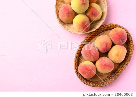 Peach fruit in basket on pink background, Top view Peach fruit in basket on pink background, Top view 88460008