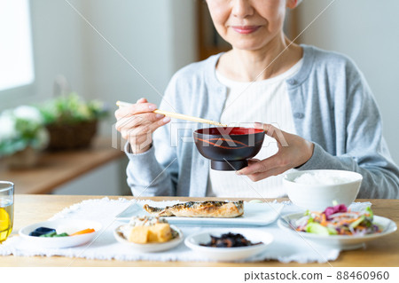 Senior woman eating breakfast Senior woman eating breakfast 88460960