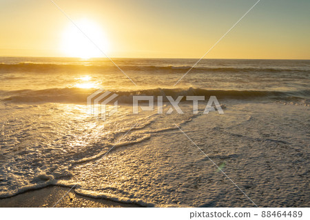 Calm waves on shore at beach against sky during sunset Calm waves on shore at beach against sky during sunset 88464489