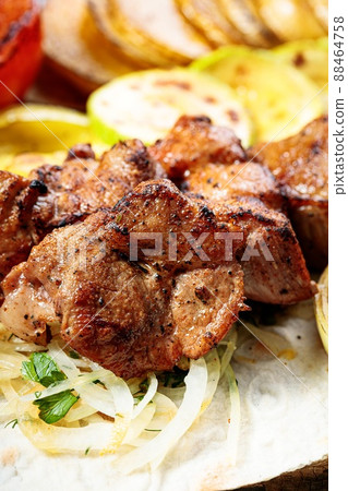 Appetizing grilled meat. Assorted vegetables. Close-up. Vertical shot. Copy space Appetizing grilled meat. Assorted vegetables. Close-up. Vertical shot. Copy space 88464758