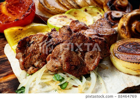 Appetizing grilled meat. Assorted vegetables and mushrooms. Close-up Appetizing grilled meat. Assorted vegetables and mushrooms. Close-up 88464769