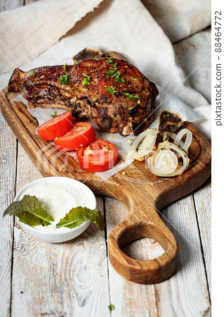 Grilled steak. Appetizing roasted meat with vegetables and herbs. Vertical shot. Copy space Grilled steak. Appetizing roasted meat with vegetables and herbs. Vertical shot. Copy space 88464772