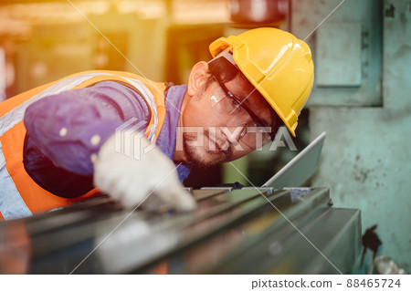 Asian Engineer worker intends to work professionally in the steel industry, high precision detail job. Asian Engineer worker intends to work professionally in the steel industry, high precision detail job. 88465724