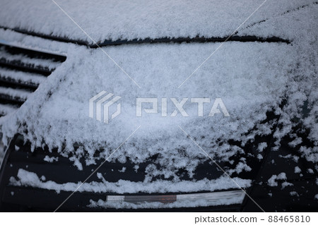 A car covered in a thin layer of snow during winter weather. A car covered in a thin layer of snow during winter weather. 88465810