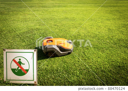 Lawn Mower Robot and Prohibition Sign of Not to Walk on the Grass 88470124