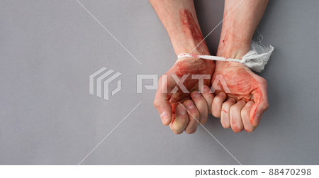 Bound bloody male hands on a gray background. The topic of killing civilians in Ukraine 88470298