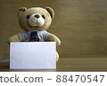 Brown teddy bears and white blank paper on brown wooden background. Birthday or anniversary greeting card concept. 88470547