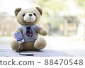 Teddy bears sitting on a wooden floor using Fingertip Pulse Oximeter to measure blood oxygen. Health concept. 88470548