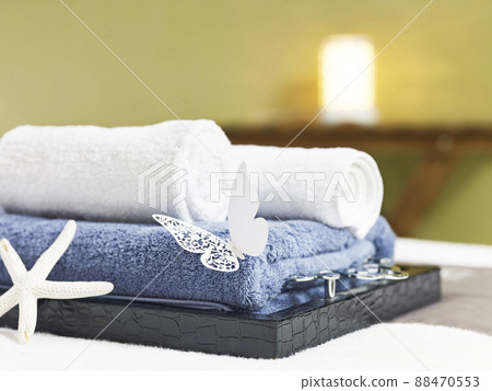 rolled towels on a tray on massage bed in beauty spa or health club 88470553