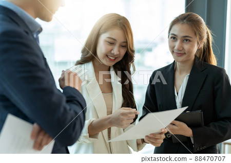 Group of happy young asian corporate people teammates meeting discussing business in office 88470707