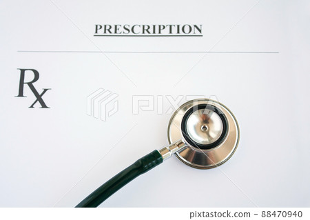 Prescription form lying on table with stethoscope 88470940