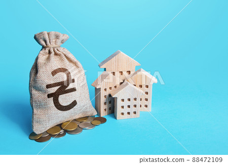 Houses and ukrainian hryvnia money bag. Real estate investment and rental business. Increasing property value. Fair market price. Home taxation. Residential or property income. Municipal budget. Houses and ukrainian hryvnia money bag. Real estate investment and rental business. Increasing property value. Fair market price. Home taxation. Residential or property income. Municipal budget. 88472109