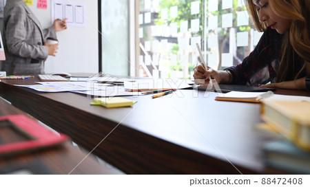 Creative designer planning application development prototype for web mobile phone. 88472408