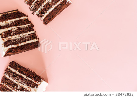 Three pieces of puff chocolate cake on pink background Three pieces of puff chocolate cake on pink background 88472922