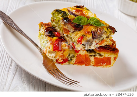 a portion of baked in oven vegetable frittata a portion of baked in oven vegetable frittata 88474136