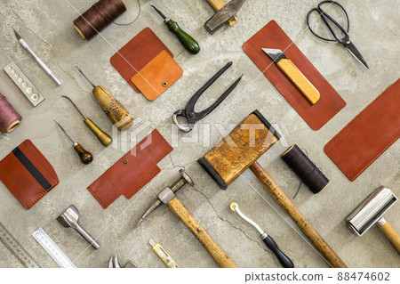 Top view materials and instruments on cutting mat for chopping measurement leatherwork details 88474602