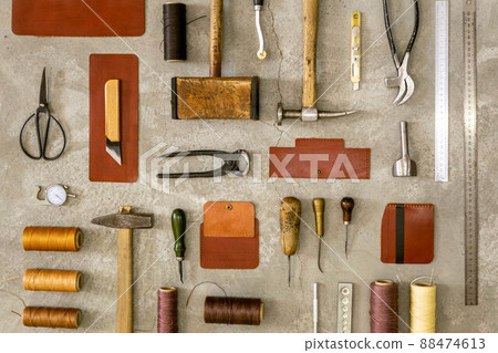 Top view materials and instruments on cutting mat for chopping measurement leatherwork details 88474613
