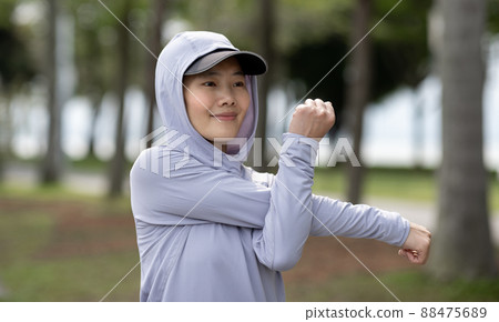 Healthy lifestyle sporty asian woman running at tropical park 88475689