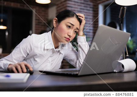 Fatigued marketing company employee with painful headache sitting tired in office workspace. Exhausted financial advisor with burnout syndrome stressed because of project deadline. 88476881