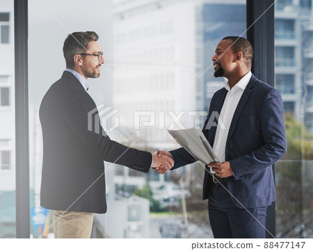 To be the best, partner with the best. Shot of two businessmen shaking hands at work. 88477147
