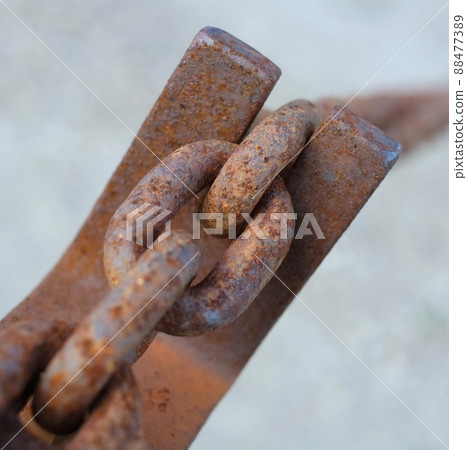 A chain is only as strong as the weakest link.... Closeup of a rusty cable chain. A chain is only as strong as the weakest link.... Closeup of a rusty cable chain. 88477389