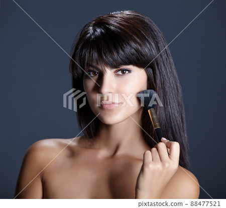 Confident and naturally beautiful. Closeup portrait of a beautiful young woman against a dark background. Confident and naturally beautiful. Closeup portrait of a beautiful young woman against a dark background. 88477521