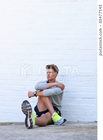 Stretching those muscles. Shot of a sporty young man stretching his legs before exercising. Stretching those muscles. Shot of a sporty young man stretching his legs before exercising. 88477548