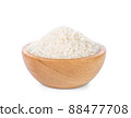 Rice in a wooden cup on a white background. 88477708