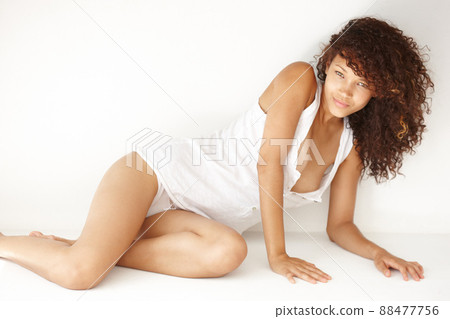 Sensuality comes naturally to her. Portrairt of a beautiful young ethnic woman leaning on her elbow. Sensuality comes naturally to her. Portrairt of a beautiful young ethnic woman leaning on her elbow. 88477756