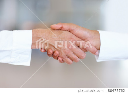 Deal. Closeup of handshake between business men. 88477762