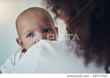 No wonder Im cute, have you seen my mom. Shot of a young woman carrying her adorable baby girl at home. 88477829