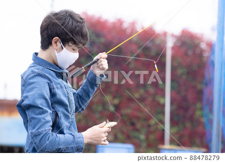 一個男孩喜歡在魚塘釣魚 88478279