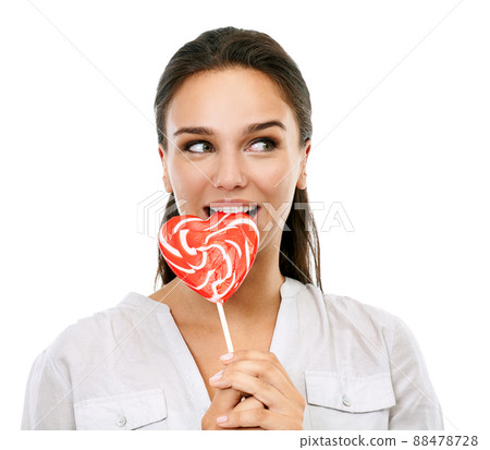 Just a little cheating on my diet.... Shot of an attractive young woman eating a lollipop isolated on white. Just a little cheating on my diet.... Shot of an attractive young woman eating a lollipop isolated on white. 88478728