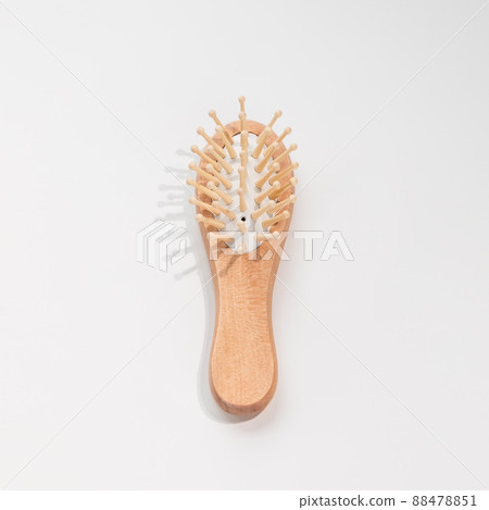 Wooden mini bamboo hair brush for travel, beard or kids on white background. Small pocket brush 88478851