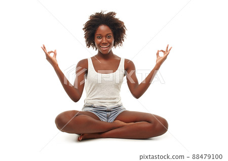 For body and mind. A young woman in a yoga position. For body and mind. A young woman in a yoga position. 88479100
