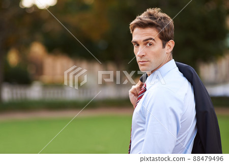 Stylish confidence. Shot of a handsome and stylish businessman in a city park. 88479496