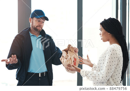 Im sorry but theres nothing I can do about this. Shot of a handsome delivery man negotiating with a dissatisfied female customer in the lobby. Im sorry but theres nothing I can do about this. Shot of a handsome delivery man negotiating with a dissatisfied female customer in the lobby. 88479756