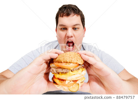 Get in my belly, burger. An obese young man about to eat a huge hamburger. Get in my belly, burger. An obese young man about to eat a huge hamburger. 88479757