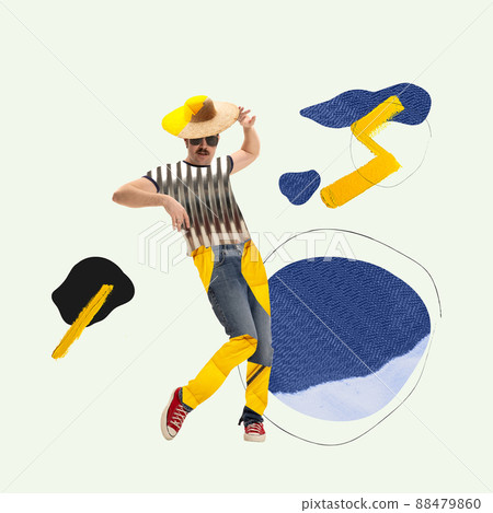 Stylish creative young man in colorful cloth from recycled materials cheerfully dancing Stylish creative young man in colorful cloth from recycled materials cheerfully dancing 88479860