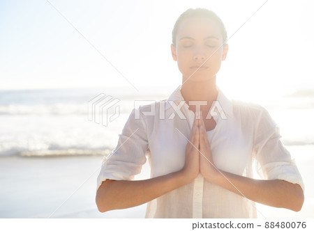 Morning meditating. A beautiful young woman meditating outside. 88480076