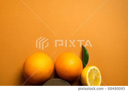 Juicy orange fruits with green leaves on an orange banner for your design. Copy space. The concept of health , diet , vitamin C Juicy orange fruits with green leaves on an orange banner for your design. Copy space. The concept of health , diet , vitamin C 88480093